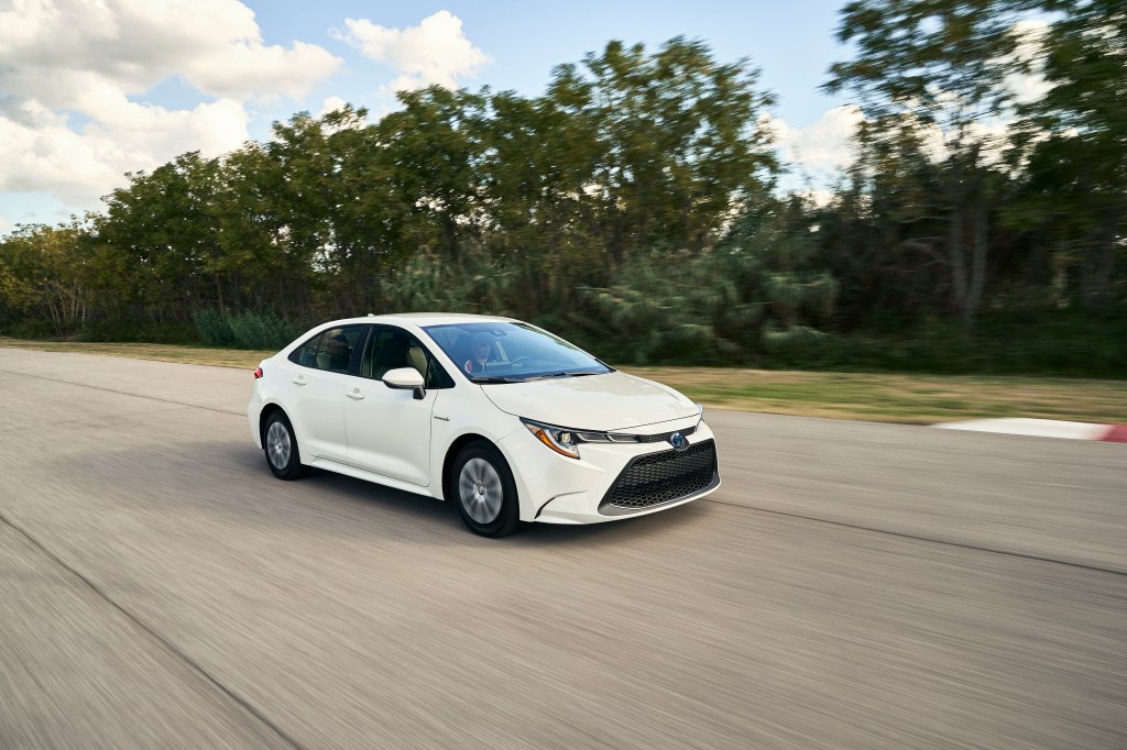 A white 2020 Toyota Corolla Hybrid slowly navigates a race track.