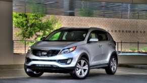 A silver 2014 Kia Sportage parked in left front angle view
