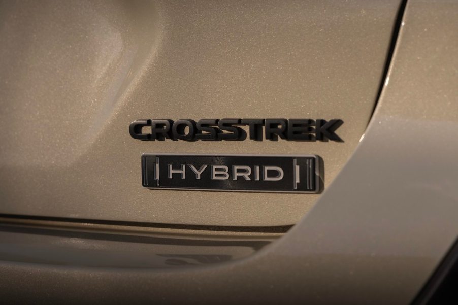 Tan Subaru Crosstrek with a Hybrid badge.