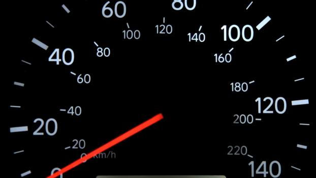 A gauge shows a car with 100K miles, which some buyers consider bad and worth avoiding.
