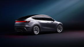 A silver Tesla Model Y shows off its refreshed look.