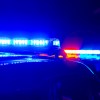 The blue lights on top of a police cruiser executing a traffic stop during a "no refusal" weekend.