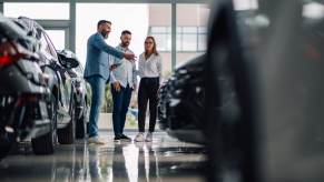 A couple at a dealership during their car-buying experience.
