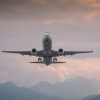 An airplane in the air during sunrise