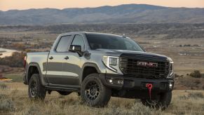 The 2025 GMC Sierra AT4X off-roading in a field