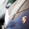 The Porsche logo on a used 911 coupe